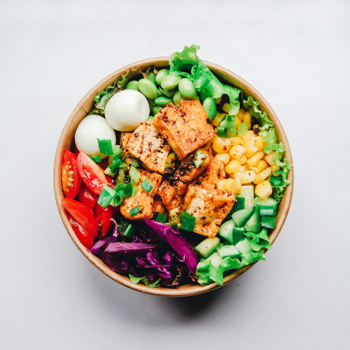 A simple, orderly meal of cooked vegetables and grain on a wooden table