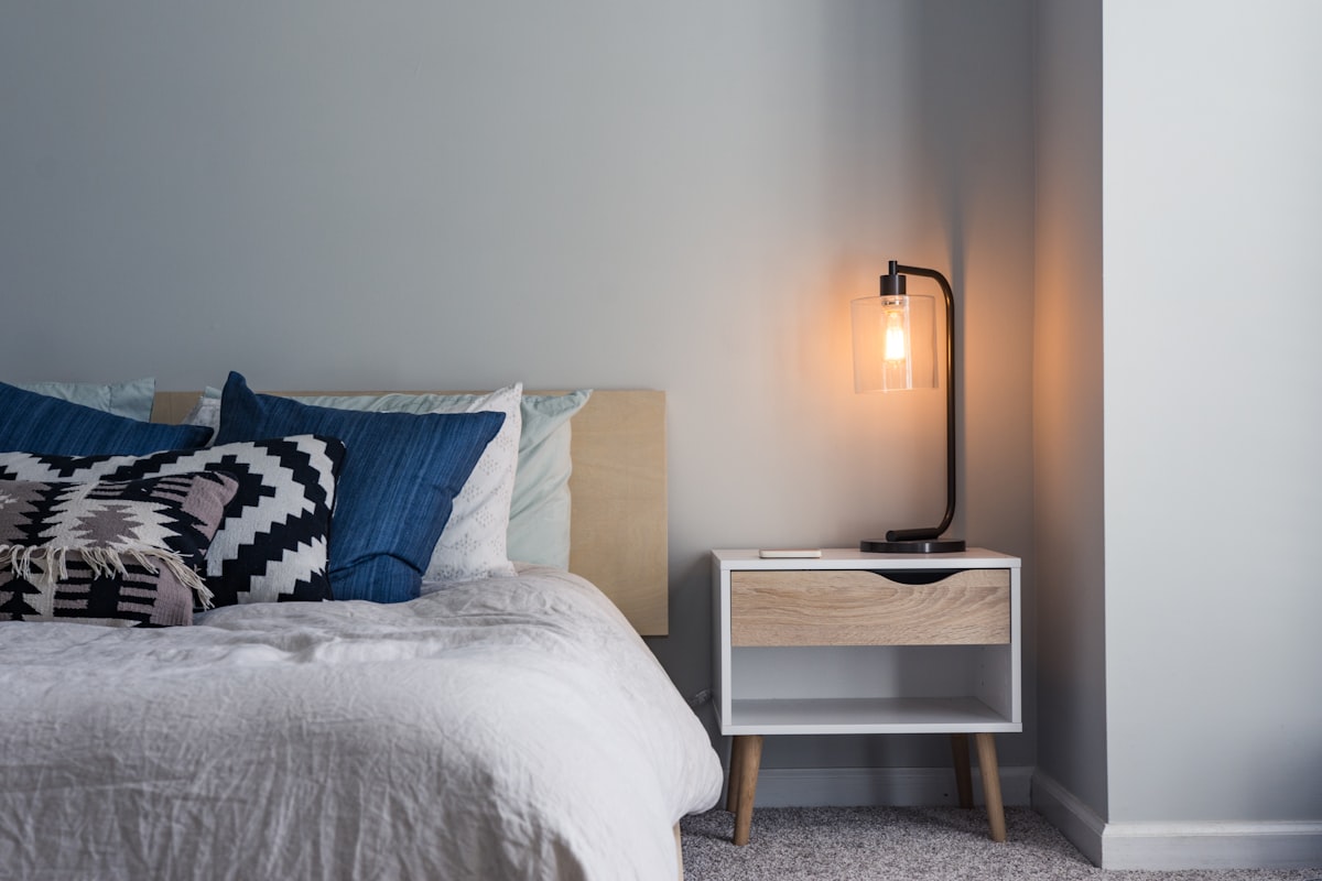 A firm ergonomic latex pillow with contour lines on a neatly made bed